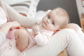 Young mother with her little cute baby daughter. Little baby girl and her mom. Mama with her child...