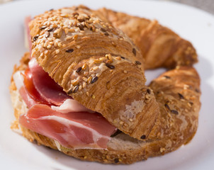 sandwich made with croissant cheese and Parma ham