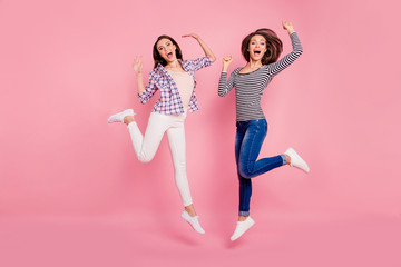 Full length body size photo of carefree playful millennial fooling raising fists yelling yes excited delighted isolated wearing jeans bright shirts on rose-colored background