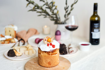 Easter cake and painted eggs. Easter composition with orthodox sweet bread, kulich and eggs on light background. Easter holidays breakfast
