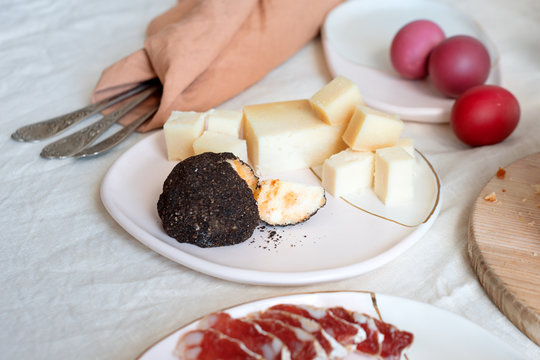 Salami and cheese, traditional italian appetizers. Easter painted eggs, serving Easter table for breakfast