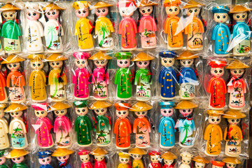 Fototapeta na wymiar Colorful figurines in the shop. Vietnam souvenirs.