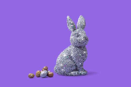 Easter Bunny Rabbit on Bright Purple Background with Easter Eggs, Conceptual Image with Copy Space