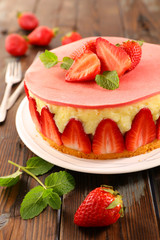 delicious strawberry cake on wood background