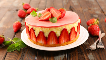 delicious strawberry cake on wood background