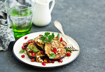 Fried eggplants with pomegranate sauce and nuts.