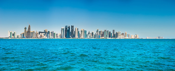 Panorama of city of Doha, Qatar downtown with skyscrapers, view from sea bay