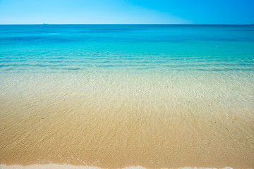 Beautiful horizon view of tropical sea and sand beach under blue sky