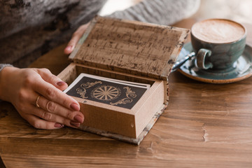 close-up of a woman's hands laying out tarot cards