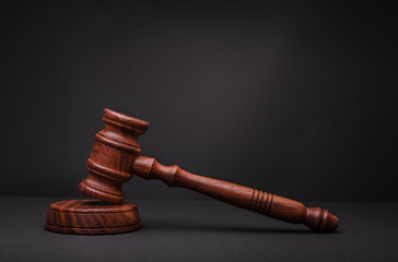 Holz Hammer mit dunklem Hintergrund urteilt und ist ein Symbol für Gesetz, Delikte, kriminelle Straftaten und Auktionen