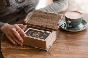 close-up of a woman's hands laying out tarot cards