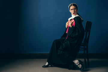 What's wrong with new emotions. Medieval young woman as a nun in vintage clothing and white mutch...