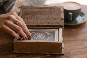 close-up of a woman's hands laying out tarot cards