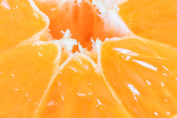 Tangerine (mandarin) in a cut close-up. Bright orange image is suitable for topics: healthy lifestyle, vitamins, proper nutrition, diet, summer, fresh juices. Background fruit texture.