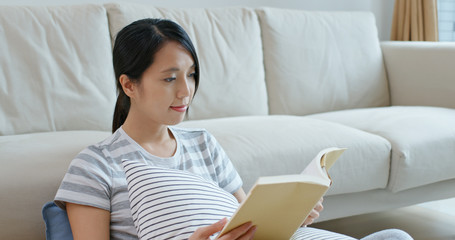 Woman read on book and sit on sofa at home
