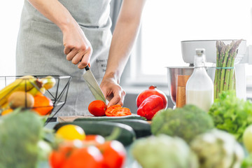 Young man chef cooking healthy salad
