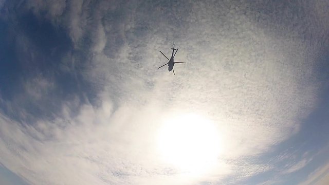 Parachutist separated from the helicopter and opens the parachute