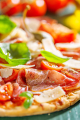 Appetizing italian pizza with prosciutto