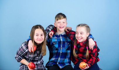 Leading a fruitful life. Little children holding red apples. Small group of children eating apples together. Cute children with healthy apple snack. Healthy children