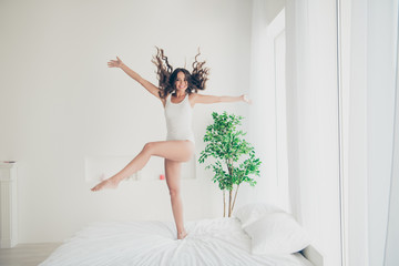 Fototapeta premium Full length body size view portrait of her she nice-looking attractive lovely charming cute cheerful cheery wavy-haired lady having fun free time in light white interior room indoors