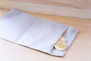 Brown bag with gold coins on wooden table background, Physical version of Bitcoin, new virtual money.