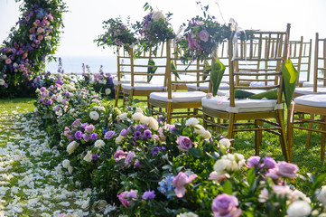 Fototapeta na wymiar Chair decorated with flowers in Wedding ceremony.