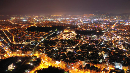 Fototapeta premium Aerial drone night shot of illuminated Athens Metropolis, Attica, Greece