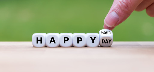 Symbol for a stress-free day. Hand turns a dice and changes the expression "happy hour" to "happy day".