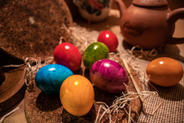 Obraz na płótnie Canvas Colorful easter eggs in wooden surrounding backgrounds