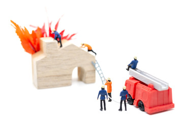 Miniature people : Firefighters with water pistols are taking care of a fire emergency