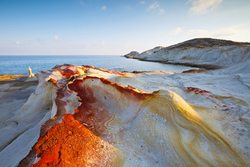 Coast nearby Mandrakia village in the north of Milos island lit by morning light.