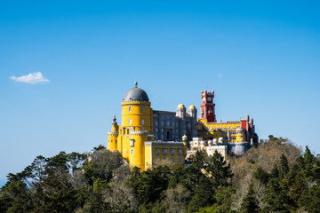 Palace of Pena in Sintra. Lisbon, Portugal. Famous landmark. Summer morning landscape with blue sky.