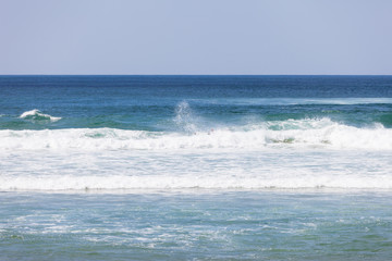 Blue ocean waves. Breaking waves at sunny day. Tropical resort