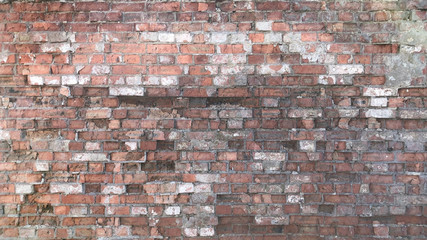 A wall with a torn brick of old age for use as a background or screen saver.