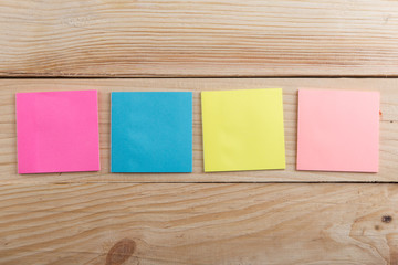 Many colorful sticky note on wooden desk. Copy space