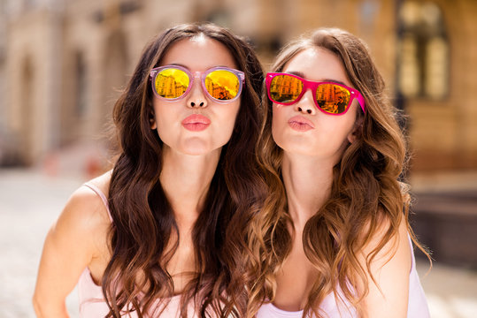 Close up photo gorgeous attractive millennial people coquettish attract boys men love lovers travel students send air kisses romance romantic long hair modern bright specs pastel outfit town center