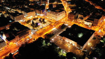 Aerial drone night shot from famous illuminated Syntagma square and Greek Parliament  building, Athens historic centre, Attica, Greece