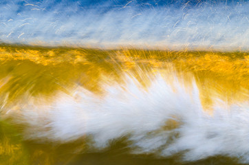 A blurred wave with vibrant yellow and blue colors