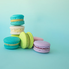 colorful macaroons on a blue square background