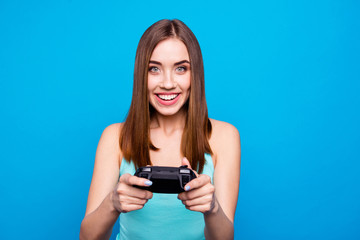Fototapeta premium Portrait of cute active energetic teen teenager having holidays using playstation feeling satisfied wearing modern top isolated on colorful background