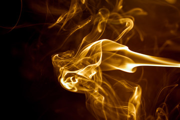 Yellow smoke on black background.