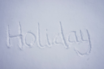 Holiday word written in a cold snow background