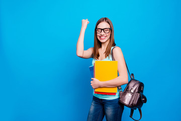 Close up photo funky beautiful amazing she her lady celebrate passing exams hold arms hands schoolgirl study applies back bag wear specs casual jeans denim tank top clothes isolated blue background