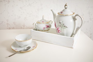 White tea service on white commode ready for use. Start a morning with cup of tea or coffee.