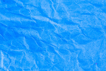 Blue vignette crumpled paper.