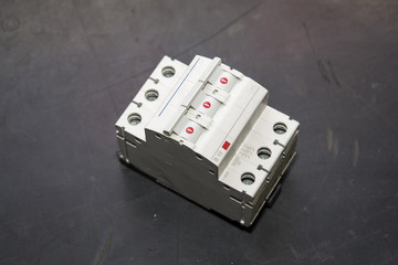 Three-phase circuit breaker lying on the table.