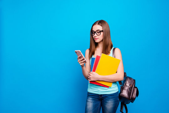 Close up photo beautiful amazing she her lady hold study applies back bag shoulder telephone hand arm curious interested reader wear specs casual jeans denim tank top clothes isolated blue background