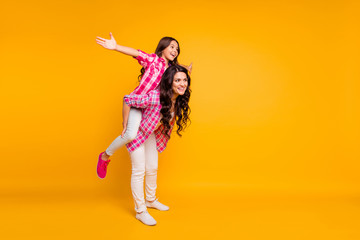 Fototapeta na wymiar Full length body size view photo of charming mom little girl have free time stroll rest feel rejoice weekends holidays satisfied dressed in trendy checked shirts isolated on colorful background