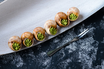 portion of Escargots de Bourgogne or Snails with herbs, view from above