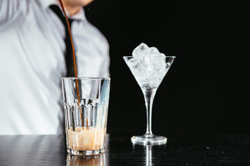 Bartender making a creamy cocktail. 